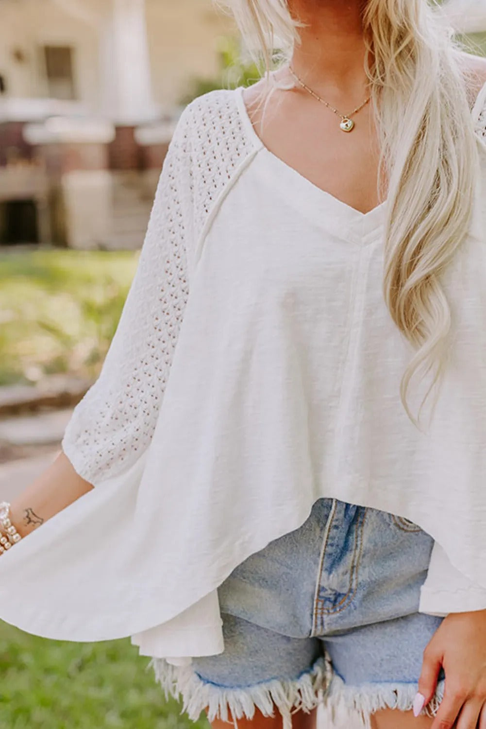 White wide-neck blouse with patchwork sleeves